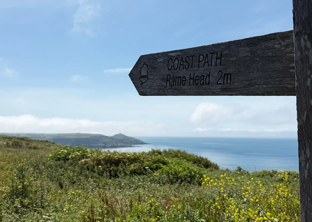 South West Coast Path signpost to Rame Head above Whitsand Bay, walking from a dog friendly holiday lodge